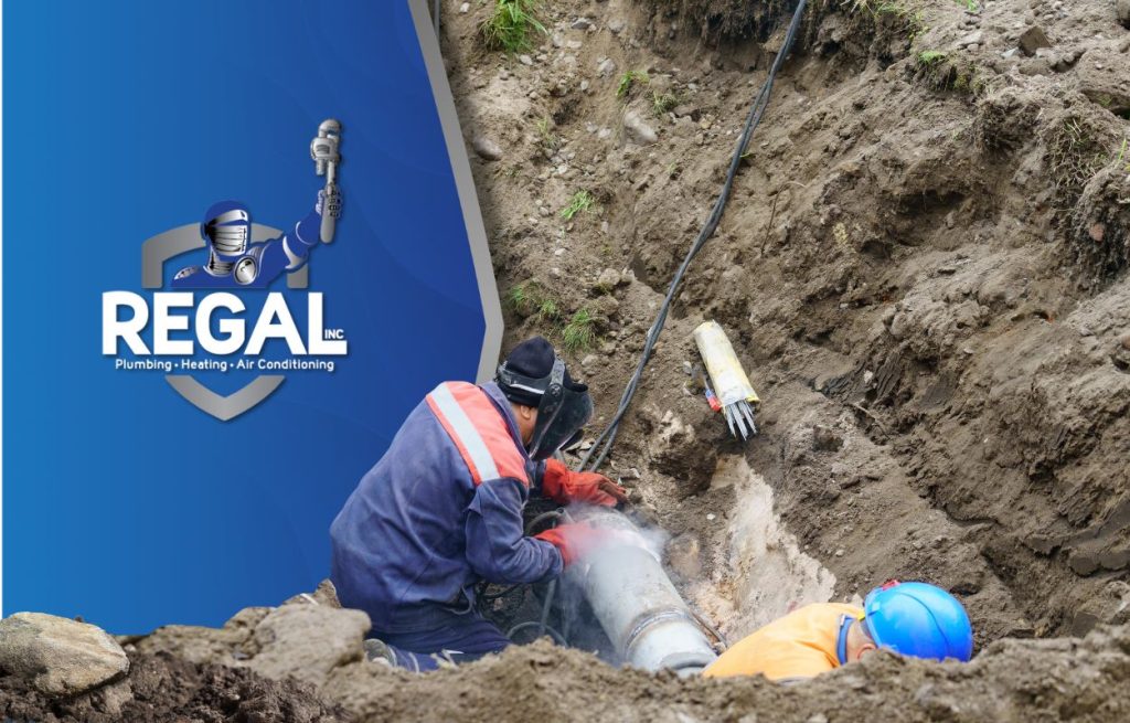 This is an image of two plumbers working on a Watermain